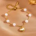 Close-up of gold titanium steel heart pendant bracelet featuring elegant white pearls - #3 Heart