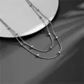 Elegante dubbellaagse roestvrijstalen slangenketting met gepolijste zilveren kubuskralen - Dubbellaagse Slangenketting Kubuskralen / C207 Staalkleur