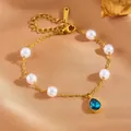 Elegant gold stainless steel pearl bracelet featuring a vibrant blue teardrop crystal pendant - Blue Teardrop Pearl