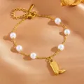 Elegant stainless steel gold pearl bracelet featuring a unique cowboy boot charm - Boots