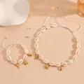 Detail view of summer shell jewelry set with golden starfish and dolphin charms - White Rope Starfish Set