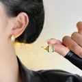 Elegant gold-plated stud earrings featuring white marble-effect inlay on a female model - Gold White Textured Style (EH3748)