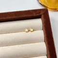 Small golden star stud earrings with pearly white inlay on cream jewelry tray display - Gold Pearl White Star Style (EH3440)