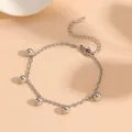 Close-up of a minimalist silver stainless steel bracelet featuring five polished ball charms - Round Bead Bracelet / Steel