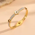 Detailed view of gold titanium steel flower bracelet with sparkling crystal paving - Gold Flower Bracelet with White Shell and Rhinestones F720