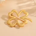 Close-up detail view of an elegant gold-plated titanium steel clover brooch for suit jackets - Four-Leaf Clover / Gold