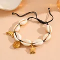 Detail of natural cowrie shell bracelet with golden sea animal charms on black cord - Fish Bracelet / Black