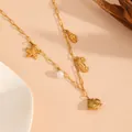 Gold stainless steel ocean beach necklace detail showing cute starfish seahorse and pearl charms. - Clownfish Beach Necklaces