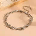 Closeup view of the multi-layer snake chain bracelet with metallic beads and clasp detail. - Bracelet / Steel