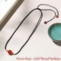 Elegant handmade black woven rope necklace featuring a red agate bead and gold spacers - Braided Cord Gold Tied (Single Bead) Necklace / Single Necklace