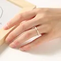 Detail showing a 2mm mini pearl ring with a gold bead on a person's finger - 2mm Artificial Pearl