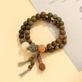 Elegant double-strand green sandalwood bead bracelet with carved floral accents and tassel - Verawood Bodhi Style