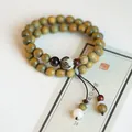 Handcrafted green sandalwood Buddhist bead bracelet with double loop and ethnic tassel - Verawood (8mm)
