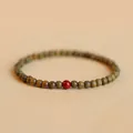 Handcrafted green sandalwood bead bracelet featuring a single vibrant red accent bead - Verawood Cinnabar Style / Red