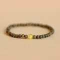 Natural green sandalwood beaded bracelet with a single amber-colored accent bead - Verawood Beeswax Style / Yellow