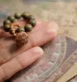 Exquisite natural green sandalwood bead bracelet featuring a detailed carved lotus pod charm - Verawood Lotus Seedpod Hand Twist / Green