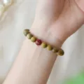 Handcrafted green sandalwood bead bracelet featuring a delicate red flower charm for women - 8mm Style
