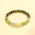 Handcrafted green sandalwood and jade bead bracelet with carved lotus flower charm - Ivory Nut Xiuyu Jade Bracelet (Women) / Light Green