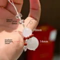 Natural white phantom crystal gourd phone charm featuring red agate bead accents - White Phantom Gourd Charm