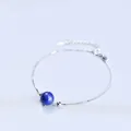 Elegant silver chain bracelet with a single blue lapis lazuli bead accent. - Platinum Plated - Lapis Lazuli