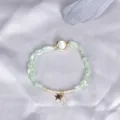 Elegant minimalist prehnite beaded bracelet with gold star charm and cat eye stone. - Prehnite