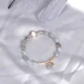 Natural grey moonstone bead bracelet with delicate gold star charm on silver satin - Labradorite