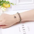 Elegant layered bracelet set with grey gemstone beads and gold chain for women on wrist. - Labradorite (Beaded Bracelet + Chain)