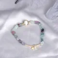 Natural irregular fluorite bead bracelet with star charm and cat-eye stone detail - Fluorite