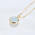 Elegant minimalist gold strawberry crystal necklace featuring a round light blue stone pendant - Aquamarine (Gold Chain)