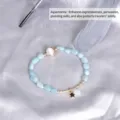 Elegant light blue stone beaded bracelet with golden star charm and round moonstone detail - Aquamarine