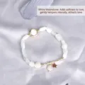 Elegant white moonstone beaded bracelet featuring a gold star charm and textured bar. - White Moonstone