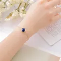 Elegant gold alloy chain bracelet featuring a round blue lapis lazuli gemstone for women - Lapis Lazuli