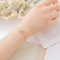 Elegant Korean style gold alloy bracelet with a dainty white lucky stone charm. - Prehnite