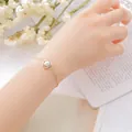 Elegant gold chain bracelet featuring a polished white marble stone charm for women - Howlite