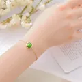 Elegant minimalist gold chain bracelet featuring a round green gemstone for women - Imperial Pinetree Stone