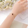 Elegant women's gold chain bracelet with round dark brown lucky gemstone - Tiger's Eye