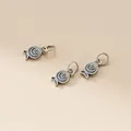 Macro detail showing the antique 925 sterling silver fish charms with spiral patterns - Washed Black