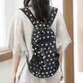 Stylish women's casual nylon backpack featuring a classic black and white polka dot design - Black