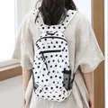 Stylish white nylon backpack featuring black polka dots and a matching small side pouch - White