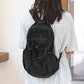 Versatile black nylon backpack featuring bungee cord detailing and side pockets - Black