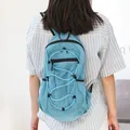 Lightweight blue checkered nylon backpack featuring a stylish front drawstring design. - Blue