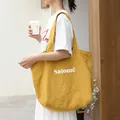 Minimalist yellow linen tote bag with white Salomé letter print and shoulder straps - Yellow