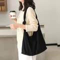 Minimalist black suede shoulder bag with knot detail for Japanese casual lifestyle wear. - Black