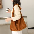 Large brown faux suede hobo bag with stylish knot detail on shoulder strap. - Brown