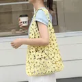 Yellow floral lace shoulder bag with hollow-out design and inner drawstring pouch. - Yellow