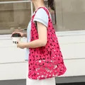Vibrant hot pink floral lace cutout tote bag featuring a white drawstring inner pouch - Rose Red