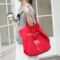 Stylish red nylon tote bag with a white palm tree and holiday slogan print design - Red