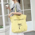 Stylish yellow nylon tote bag featuring palm tree print and holiday slogan for women - Yellow
