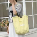 Casual light yellow nylon tote bag featuring Beach text print for women's daily use - Yellow