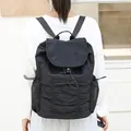 Mochila de nailon plisada negra casual con solapa de cordón y bolsillos laterales. - Negro
